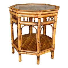 a round wooden table with glass top and bamboo frame on the bottom, against a white background