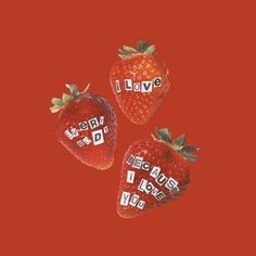 three strawberries with the words i love you written on them in red and white