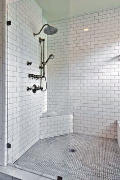 a walk in shower sitting next to a white toilet