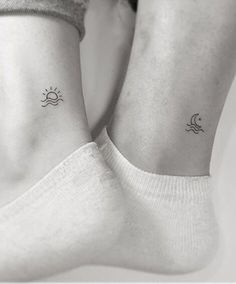 two people with matching tattoos on their feet, one has a sun and the other has a moon