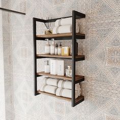 a shelf with towels, soaps and other items on it next to a wall