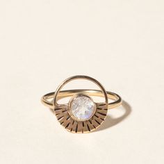 The moon may shine by reflecting the sun's rays, but that silvery light has an allure all its own. Britta Ambauen captures our satellite's radiance in her beautifully handmade ring. At the center rests a gleaming moonstone, a gem believed to provide the wearer with inspiration, a sense of calm, and enhanced intuition. The setting, made from recycled 14-karat gold cast in a hand-carved mold, features a half-halo design to re-create the moon's heavenly glow. The gold's warmth also accentuates the cool, white-blue iridescence of the stone. Britta's hand-craftsmanship not only results in a luminous piece of jewelry, but one that future generations of stargazers will find just as captivating. Handmade in Washington. Heirloom Jewelry, Too Hot To Handle, Moonlit Night, Uncommon Goods, Bar Jewelry, Heirlooms Jewelry, Month Gifts, Handmade Beauty Products, Handmade Ring