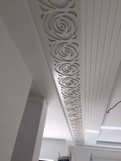 a room with white walls and ceilinging that has circular designs on the ceiling above it