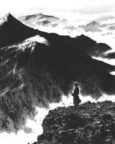 a person standing on top of a mountain with an umbrella over their head and clouds in the background