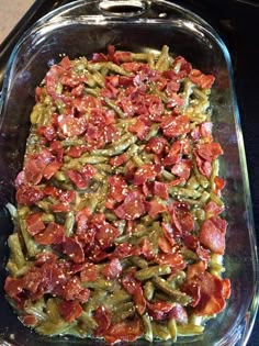 a casserole dish filled with green beans, bacon and other toppings on top