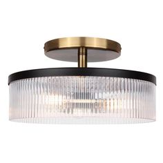 a semi flush ceiling light fixture with clear glass and brass finish, on an isolated white background