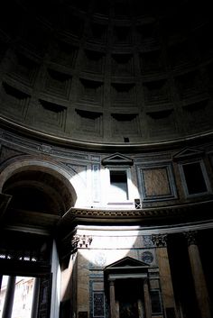 the inside of an old building with some doors and windows in it's center