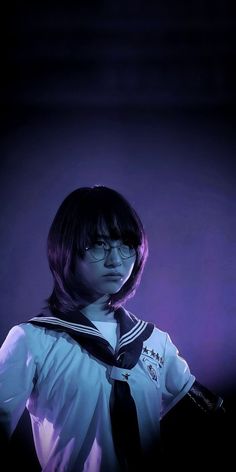 a young woman wearing glasses and a sailor's uniform is posing for the camera