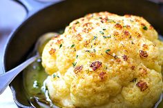 cauliflower is cooked in a skillet and garnished with parsley