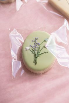 a decorated cookie sitting on top of a pink table