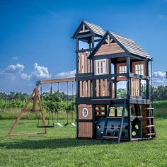 a wooden play set in the middle of a field