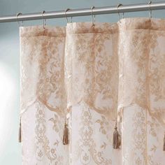 a curtain with tassels hanging from it's side