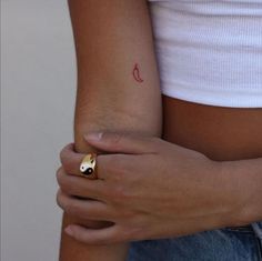 a close up of a person's arm with a ring on it