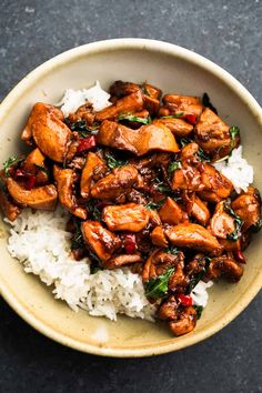 a bowl filled with rice and meat on top of a table