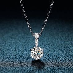 Discover a world of lustrous opulence with the Classic 1.0 Ct Round Cut Moissanite Pendant Necklace from Evani Naomi Jewelry. This stunning piece flaunts a 1.0 carat round cut moissanite that delivers a level of sparkly brilliance sure to captivate and impress. Each necklace is finely handcrafted to last a lifetime, showcasing not only the beauty of the design but also its superior craftsmanship. Made from high-quality 92.5% pure silver and 7.5% hypoallergenic metals, it's dipped five times in p Blood Diamonds, Moissanite Pendant, Blood Diamond, Moissanite Necklace, Cvd Diamond, Classic Engagement Rings, Silver 925 Necklace, Black Diamonds, Solid Gold Jewelry