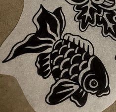 some black and white stickers on top of a paper with fish in the middle