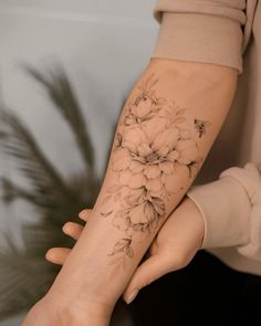 a woman's arm with flowers on it