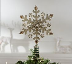 a small christmas tree with a snowflake on top