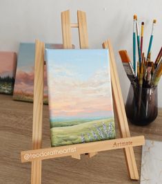 an easel with some paintings on it