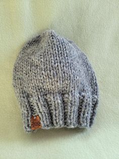 These 100% wool toques are hand knit and detailed, made with my own pattern and materials sourced from small and local businesses. While these hats aren't as luxurious as alpaca, they're very warm and comfortable! Designed to fit the average adult (you may need to stretch the brim with your hands; this won't damage the hat!) as well as toddlers and children with the brim folded up. I always say- I have a giant head, and all these toques are made to fit me! Approximately 15" circumference and 9.5 Handmade Beanies, Hat Handmade, Wool Hat, Folded Up, Sheep Wool, Local Businesses, Alpaca, Halloween Shopping, Hand Knitting