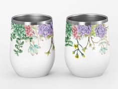 two white cups with purple flowers painted on them, one has green leaves and the other has pink roses