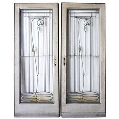 two stained glass doors with flowers on the top and bottom panels, both side by side