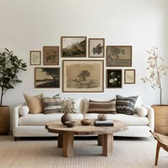 a living room filled with lots of furniture and pictures on the wall above it's coffee table