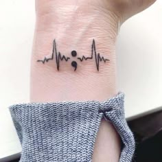 a small heartbeat tattoo on the wrist