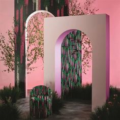 a pink and green room with two chairs in front of an arch that has trees growing out of it