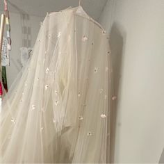 a white dress hanging up in a closet