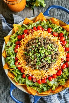 a large bowl filled with taco salad and tortilla chips