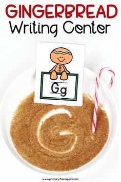 a gingerbread writing center on a white plate with candy canes and cinnamon sticks