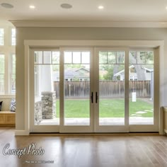 an empty room with sliding glass doors and wood flooring in the center is shown