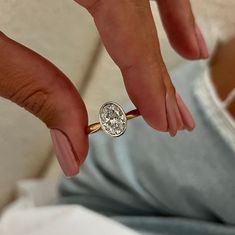 a close up of a person holding a ring