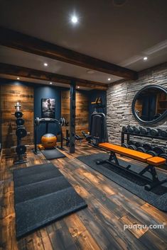 a home gym with wooden floors and stone walls