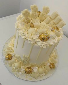 a cake with white frosting and gold decorations