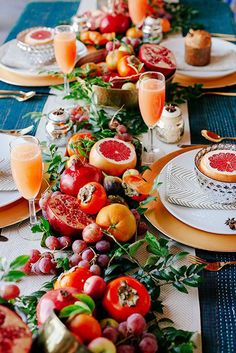 the table is set with plates and fruit