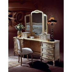 an antique vanity with mirror, stool and lamp