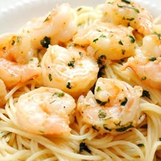 pasta with shrimp and herbs in a white bowl