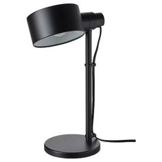 a black table lamp with a white light on it's side and a black base