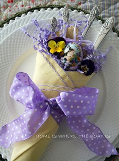 a white plate topped with a wrapper filled with candy and candies covered in purple polka dots