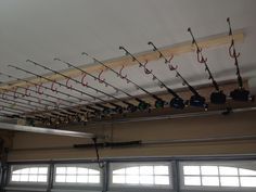 there are many fishing rods hanging from the ceiling above the garage door and on the roof