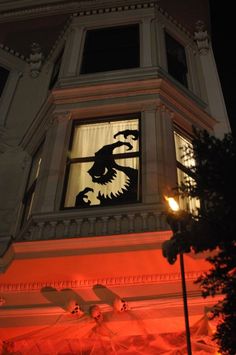 a building with a clock on the side and an eagle cutout in the window