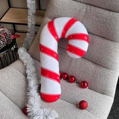 a large candy cane sitting on top of a chair