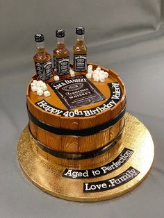 a birthday cake made to look like a barrel with four bottles on top and the words happy 40th birthday written on it