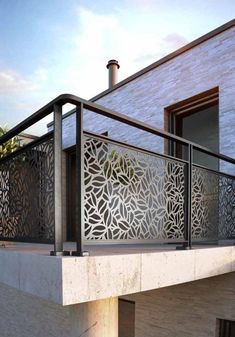 an outdoor balcony with metal railings and decorative screens