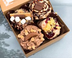 a box filled with lots of different types of desserts on top of a table