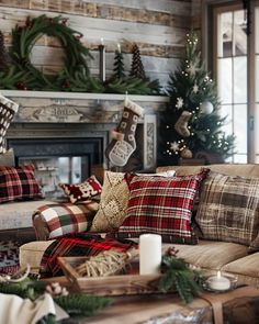 a living room decorated for christmas with plaid pillows and stockings on the fireplace mantel