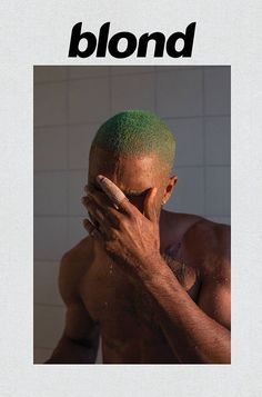 a man covers his face with his hands while standing in front of a tiled wall