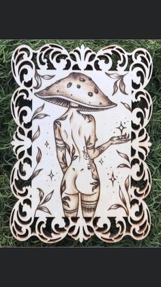 a wooden plaque with an image of a woman holding a mushroom on it's back